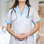 woman in white button up shirt and blue stethoscope