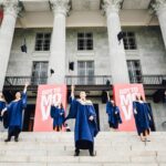 graduates in front of building