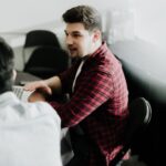 a man sitting in front of a laptop computer