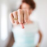 woman showing gold-colored ring