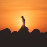 person standing on rock platform