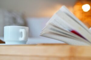 a cup of coffee and a book on a table