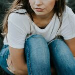 shallow focus photo of person in white scoop-neck T-shirt